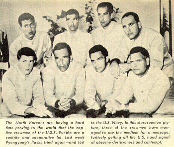 North Korean Propaganda Photograph of prisoners of USS Pueblo. Photo and explanation from the Time Magazine article that blew the Hawaiian Good Luck Sign secret. The soldiers were flipping the middle finger, as way to covertly protest their captivity in North Korea, and the propaganda on their treatment and guilt. The North Koreans for months photographed them without knowing the real meaning of flipping the middle finger, while the sailors explained that the sign meant good luck in Hawaii.